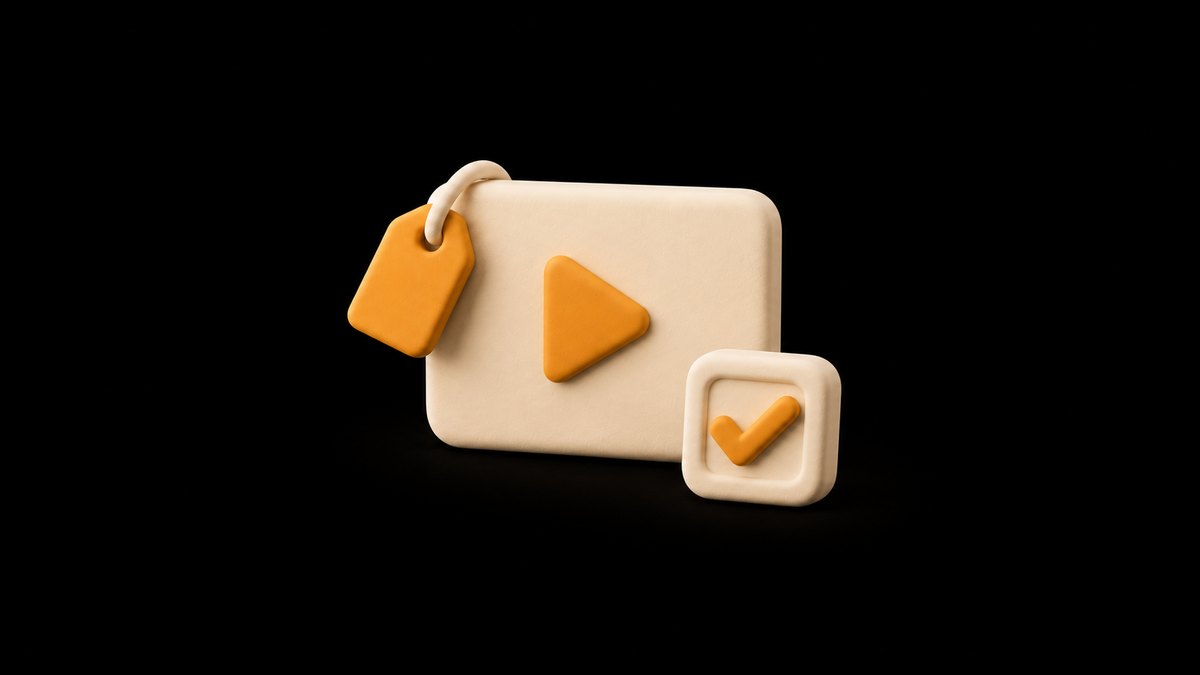 A cream clay video screen with an amber play button and an amber tag hanging from its corner, and a clay check box with an amber tick in front, on a black background.